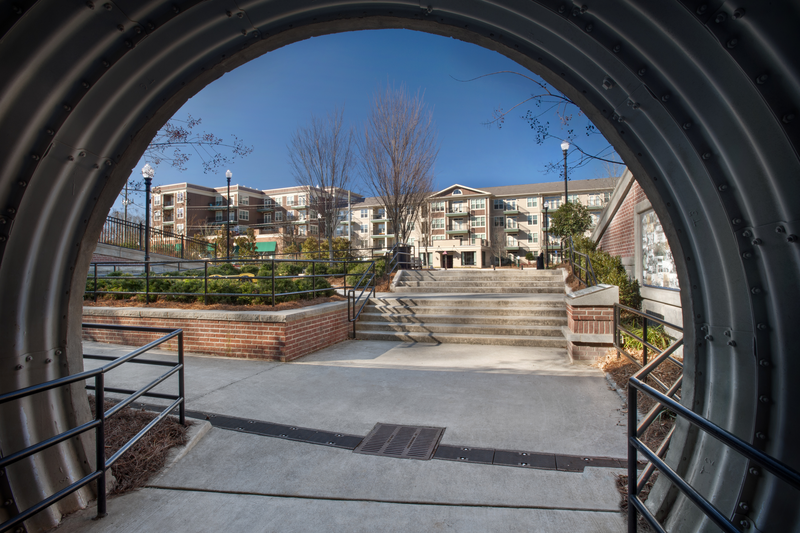 Exterior courtyard view looking up stairs from covered walk way