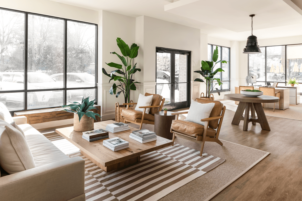 a living room with a couch and chairs and a coffee table