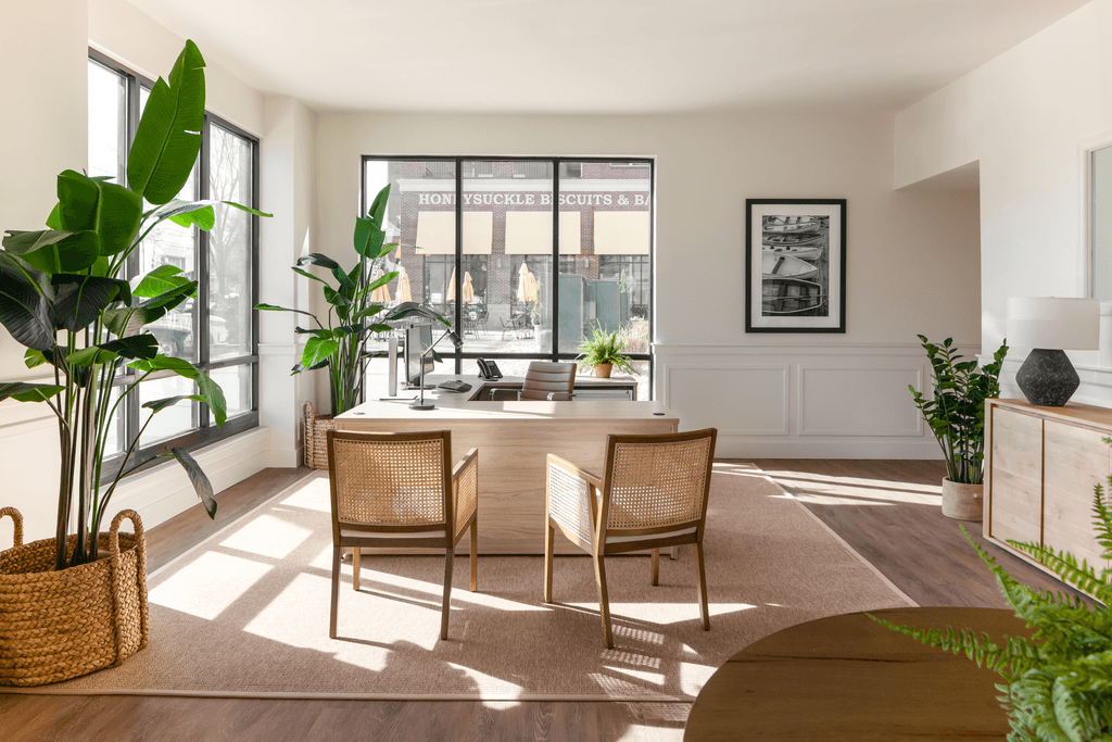 a living room with a table and chairs and a window