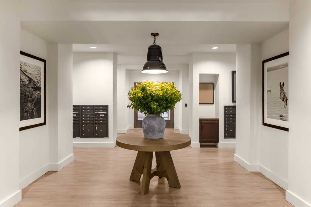 a dining room with a table and a vase with yellow flowers