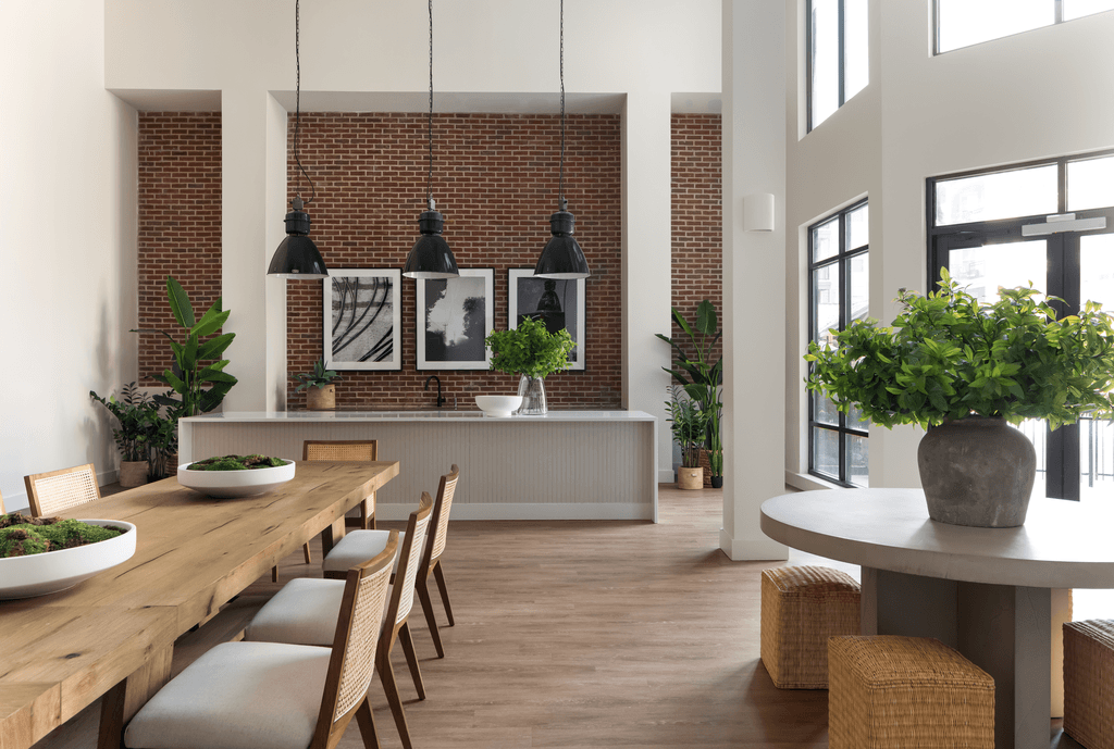 a dining room with a long wooden table and chairs and a large window