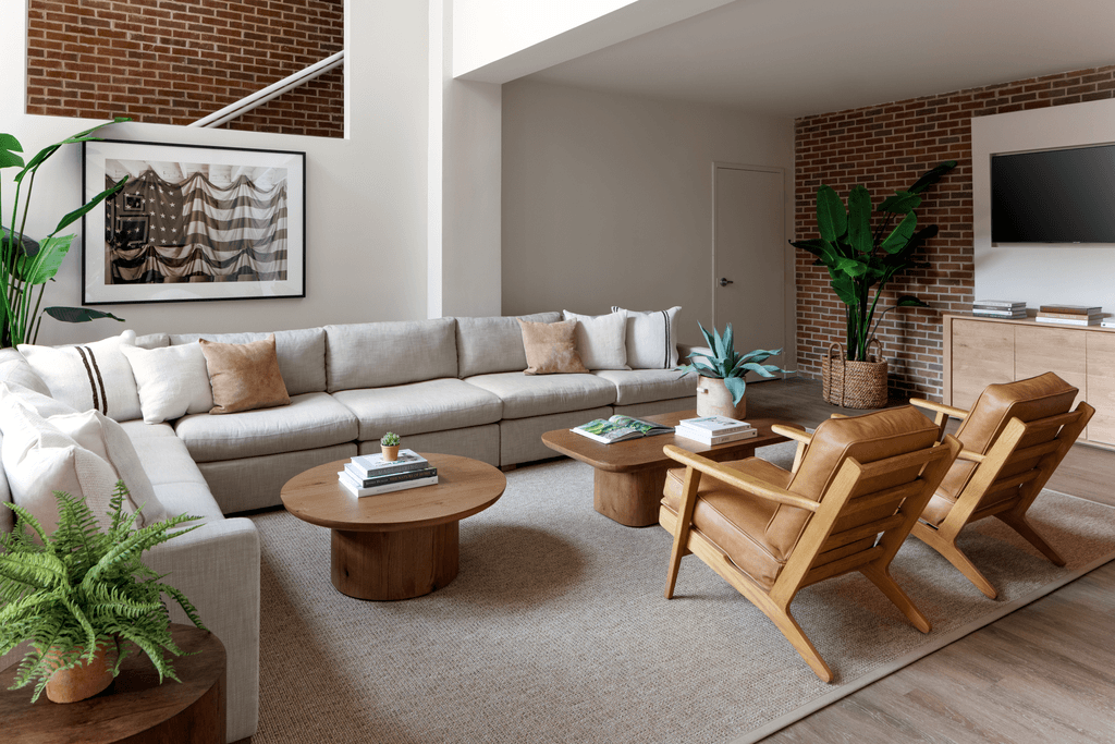 a living room with a couch and chairs and a television