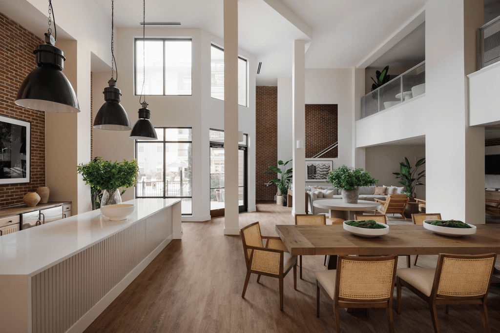 a living room and dining room with a table and chairs