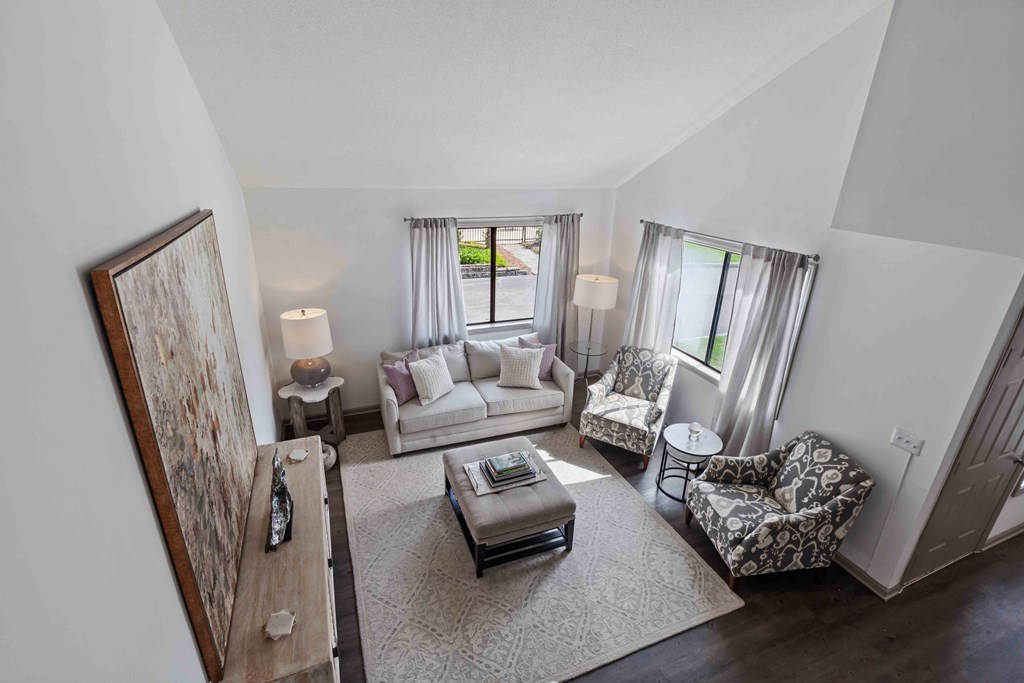 A living room with a couch, chairs, and a coffee table.