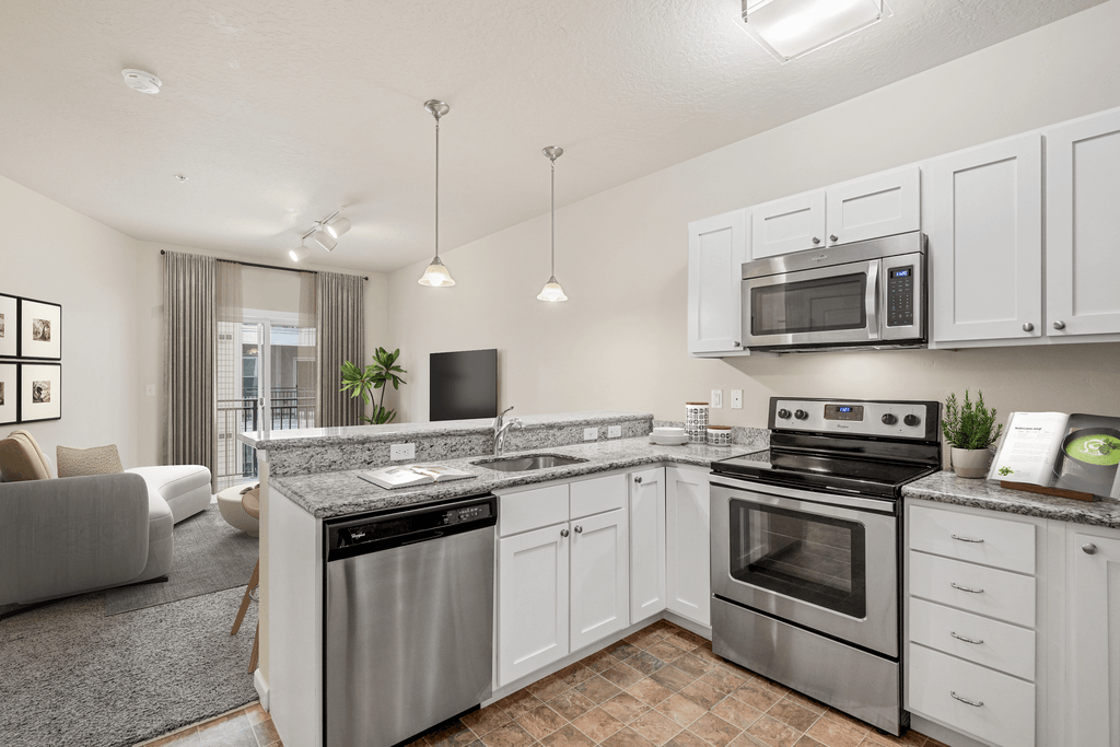 a kitchen with stainless steel appliances and white cabinets