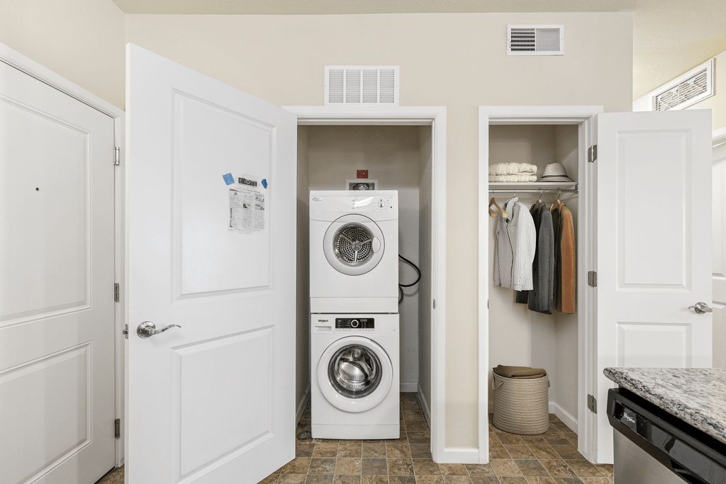a small laundry room with a washing machine and a washer and dryer