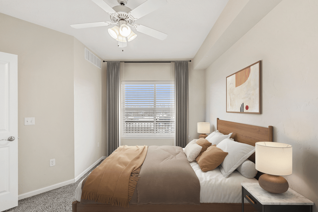 a bedroom with a large bed and a ceiling fan
