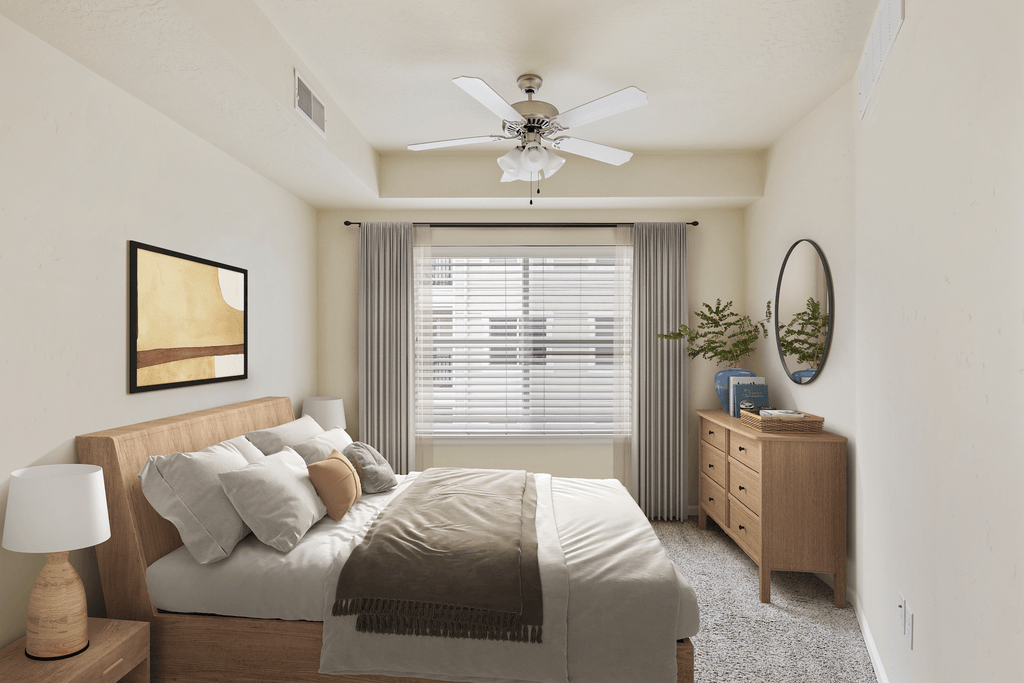 a bedroom with a bed and a ceiling fan