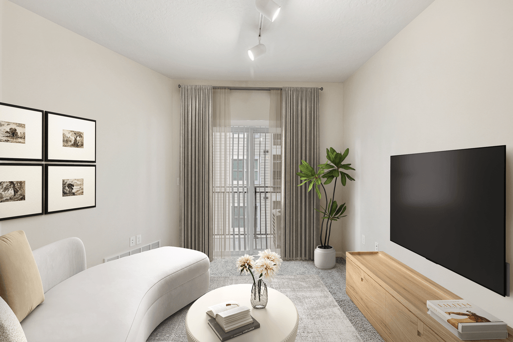 a living room with a white couch and a television