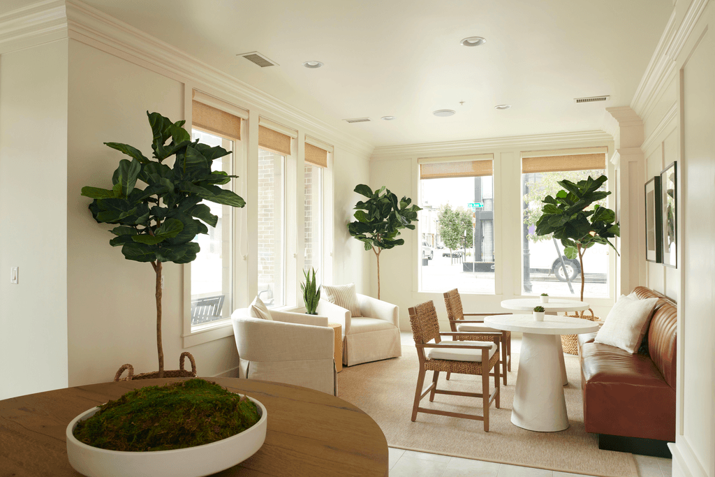 a living room with a table and chairs and a couch