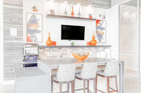 a kitchen with a center island and four stools in front of a kitchen counter
