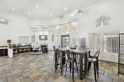 A dining room with a table and chairs.