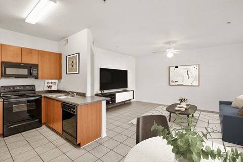 A kitchen with a black oven and microwave, a black fridge, a black countertop, and a black dishwasher.