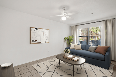 A living room with a blue couch and a coffee table.