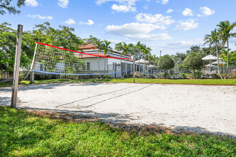 a volleyball court with a net in front of a house