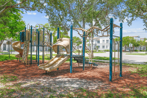 a playground with slides and monkey bars at the whispering winds apartments in pearland, tx