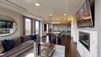 Resident sky lounge facing a pool table and sitting area complete with a television and fireplace. - Photo Gallery 57