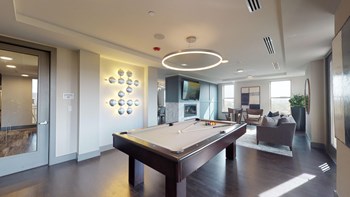 Resident sky lounge facing a pool table and sitting area complete with a television and fireplace. - Photo Gallery 27