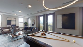 Resident sky lounge facing a pool table and sitting area complete with a television and fireplace. - Photo Gallery 26