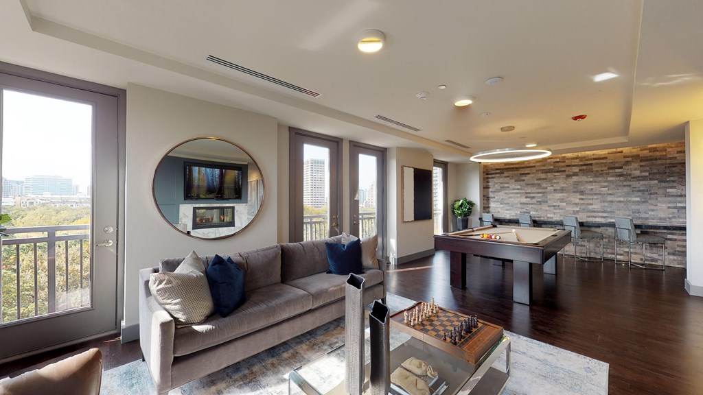 Resident sky lounge facing a pool table and sitting area complete with a television and fireplace.