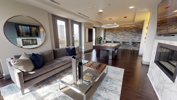 Resident sky lounge facing a pool table and sitting area complete with a television and fireplace. - Photo Gallery 63