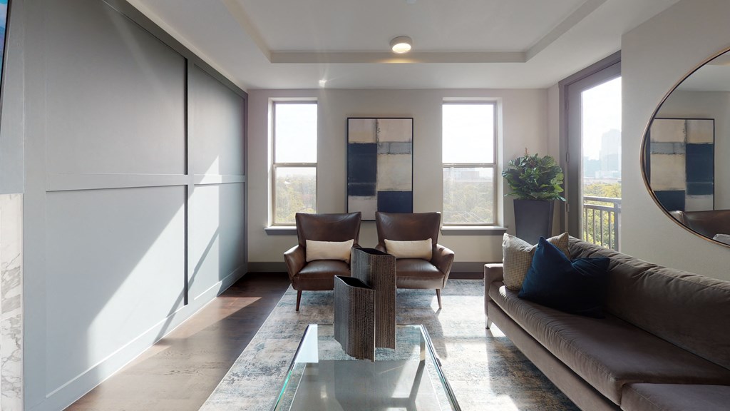 Resident sky lounge facing a table and sitting area complete with a television and fireplace.