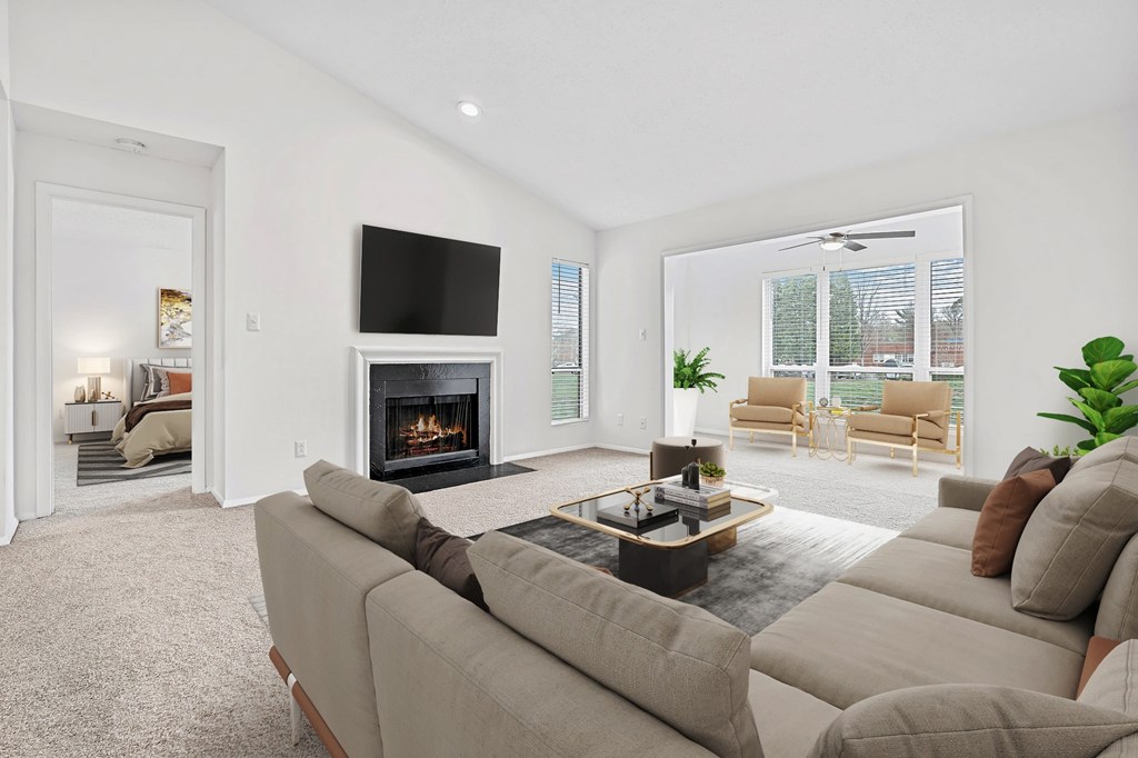 A living room with a fireplace and a television. at Southpark Commons Apartment Homes, Charlotte, NC, 28210