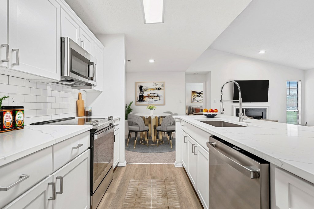 A modern kitchen with white cabinets and stainless steel appliances. at Southpark Commons Apartment Homes, Charlotte, NC, 28210