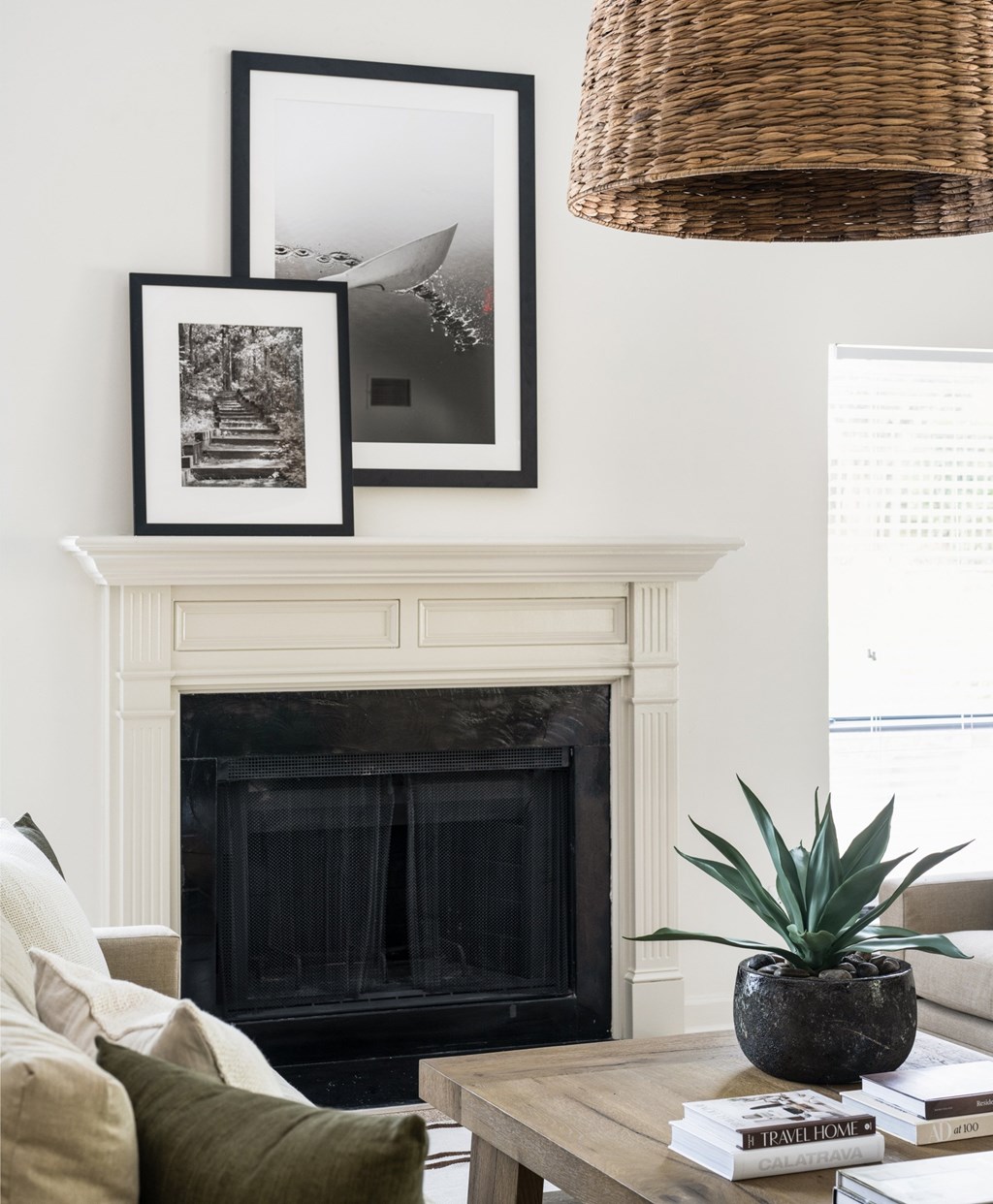 A living room with a fireplace, a couch, a coffee table, and a potted plant. at Southpark Commons Apartment Homes, Charlotte, NC