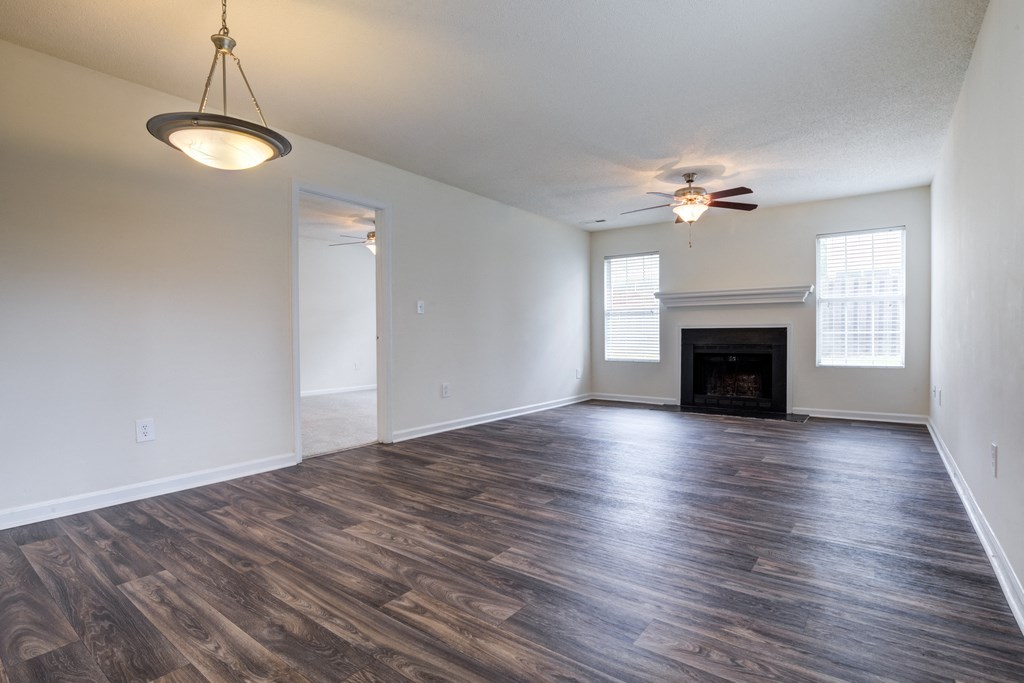 Living room and dining room with wooden floors and fireplace