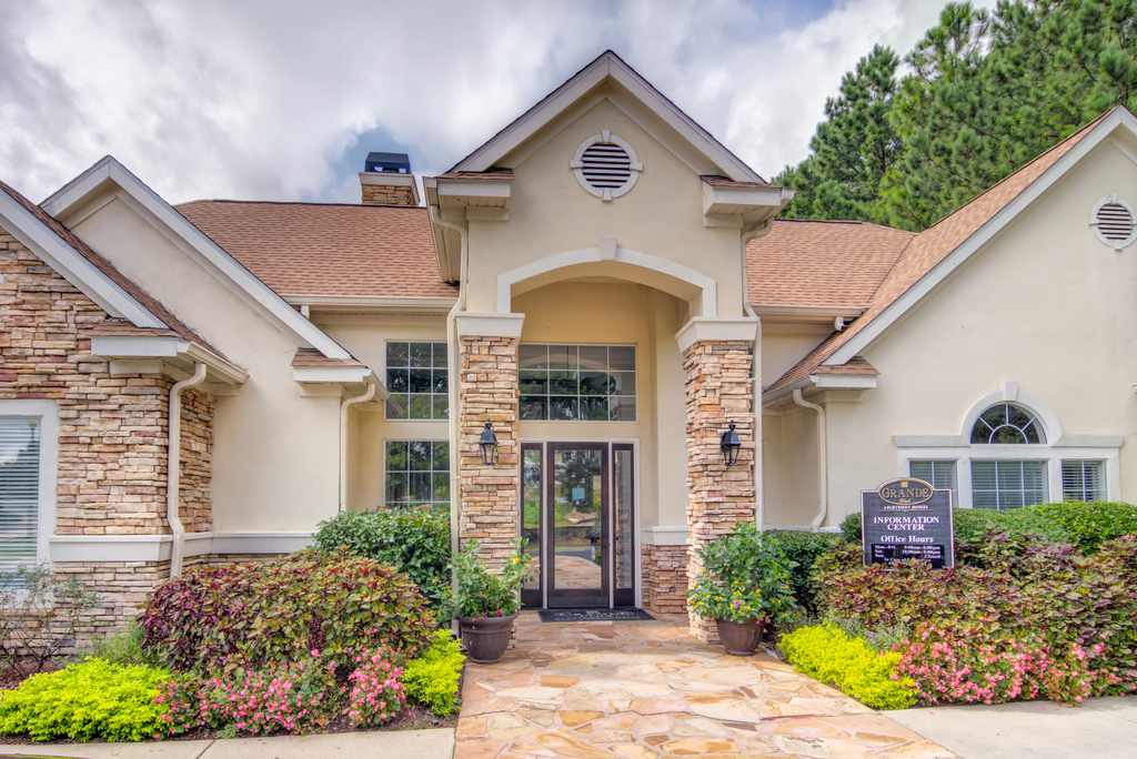 a house with a front door and a sign in front of it