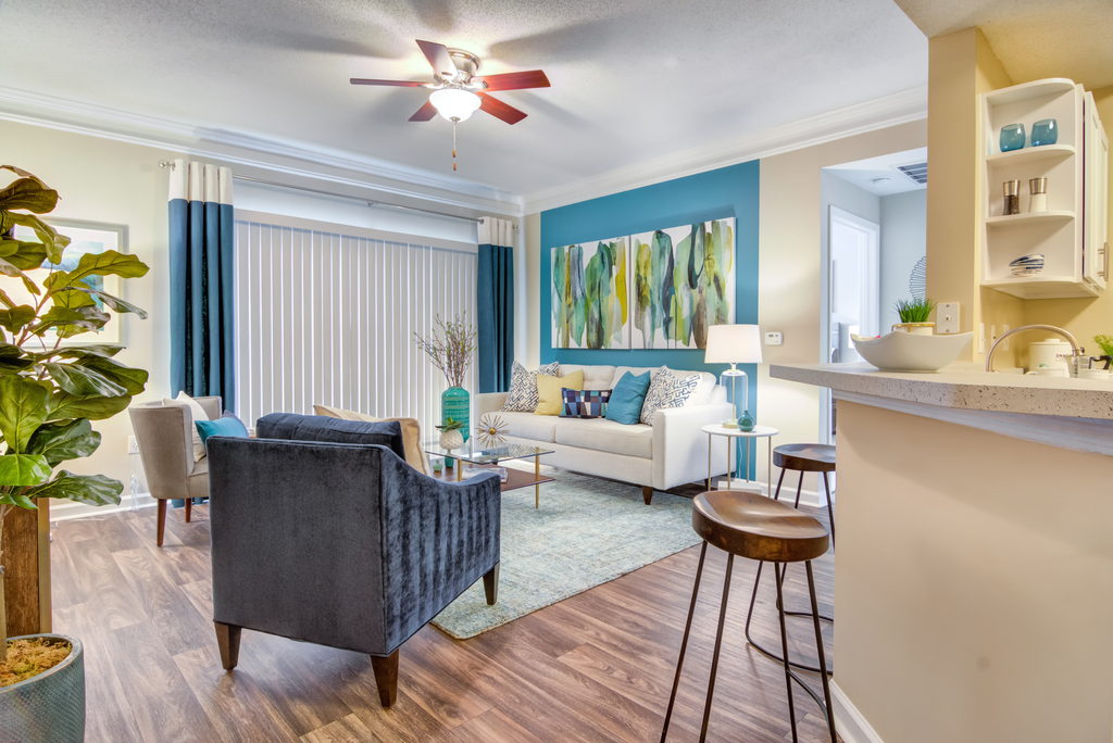 a living room with furniture and a ceiling fan