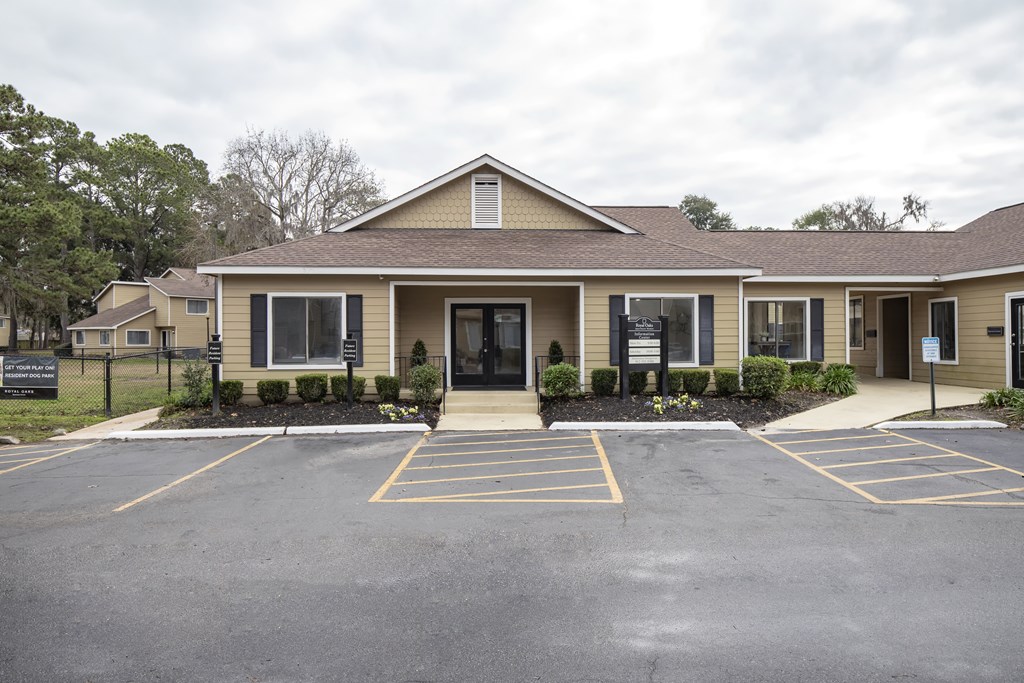 A building with a parking lot in front of it.