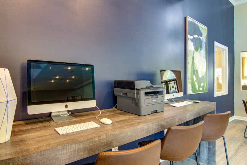 a computer and printer on a desk in a home office