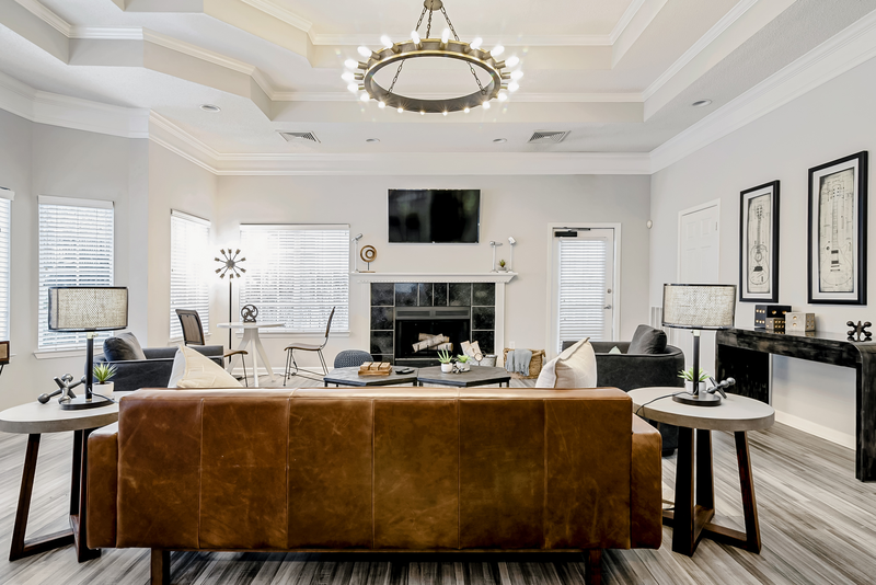 leasing office with a fireplace and a tv on the wall