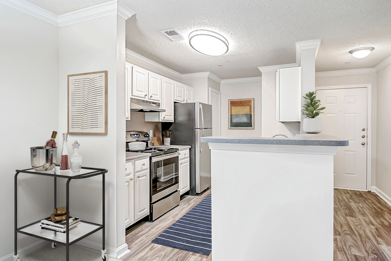 a kitchen with white cabinetry and stainless steel appliances
