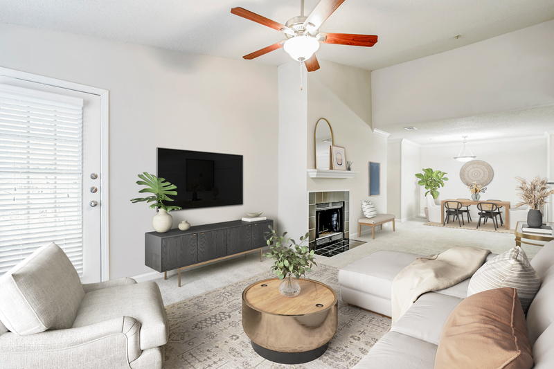 a living room with a large white couch and a large flat screen tv on the wall