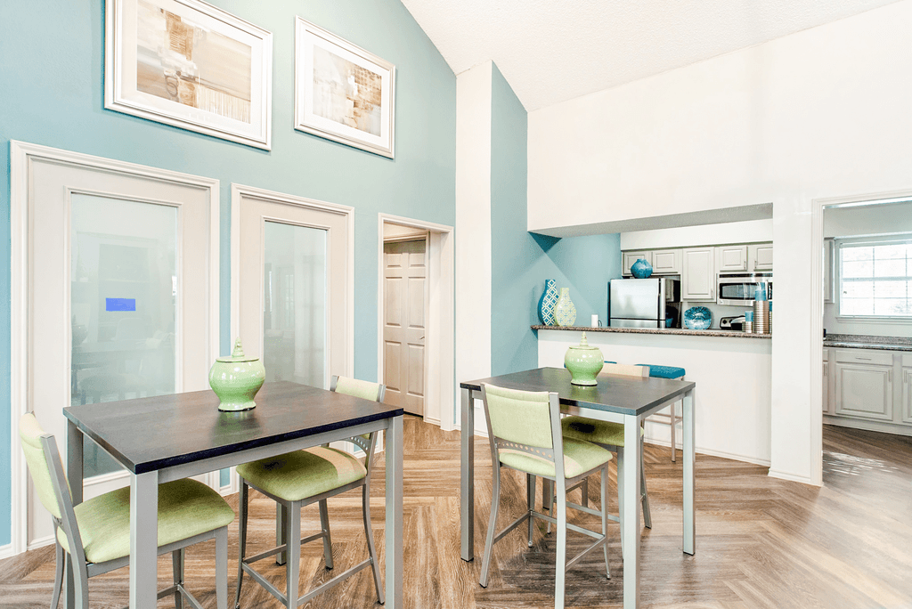 Clubhouse interior and kitchen with high top tables, granite countertop and stainless appliances