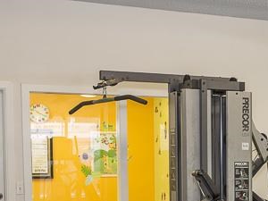 Fitness Center with Exercise Equipment and Mirror Accent Wall