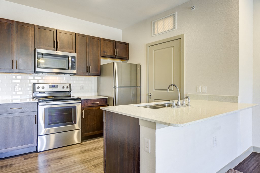 a view of a kitchen with silver appliances