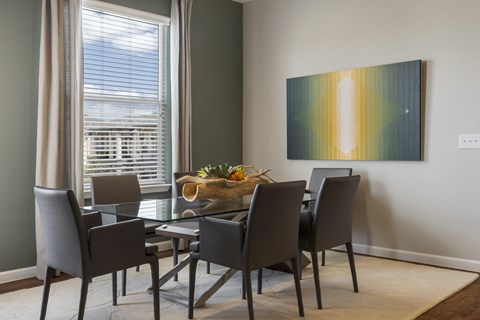 A dining room with a table set for four.