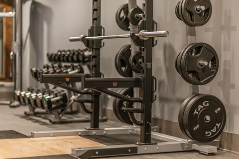 A weightlifting bar with weights on it in a gym.