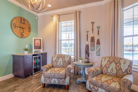 A living room with two chairs and a table.