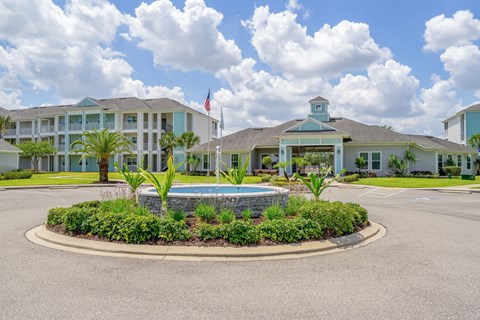 A building with a pool in front of it.