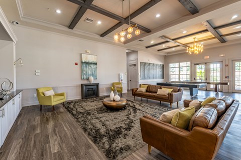 A living room with a brown leather couch and a yellow chair.