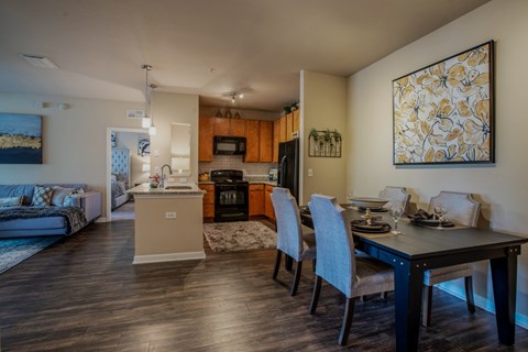 A modern kitchen with a dining table set for four.