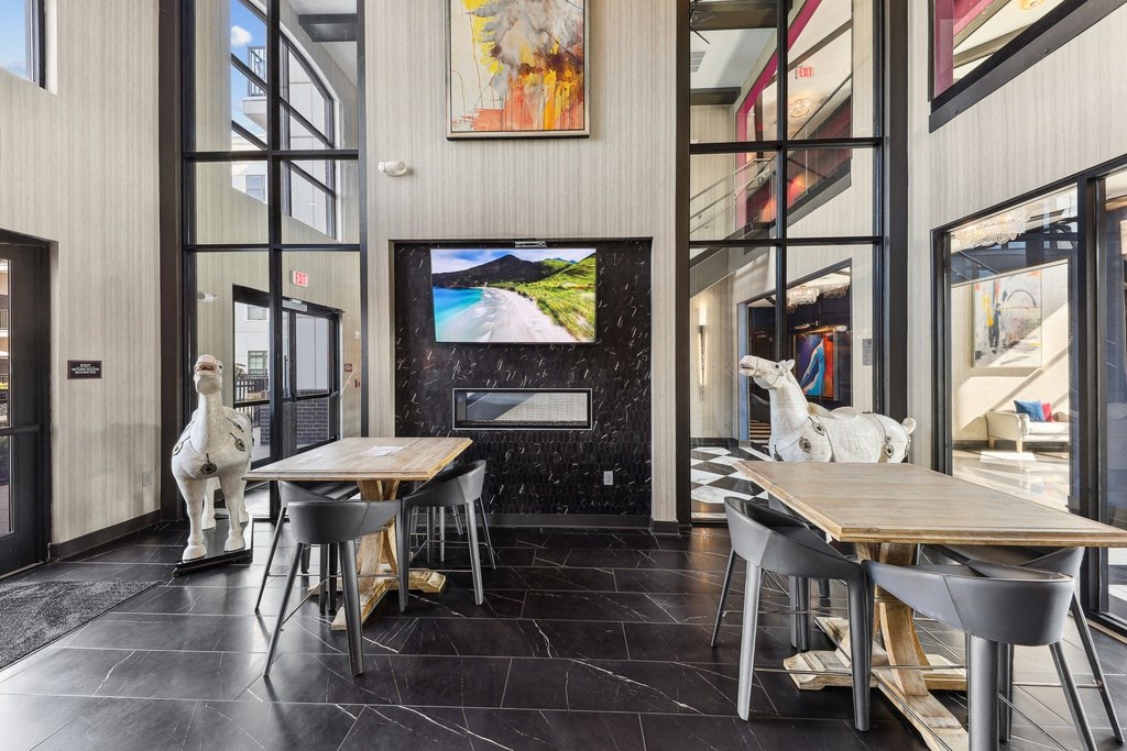A modern dining room with a wooden table and chairs.