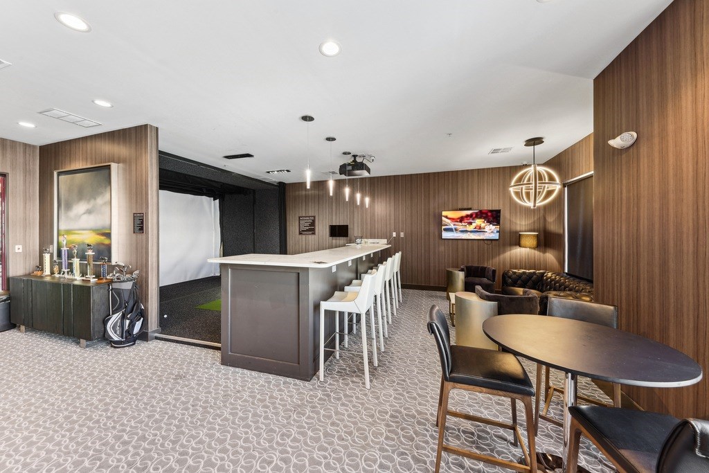 A modern dining area with a wooden table and chairs.