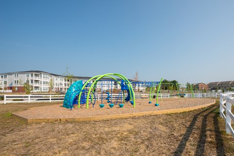 A playground with a green and blue slide.