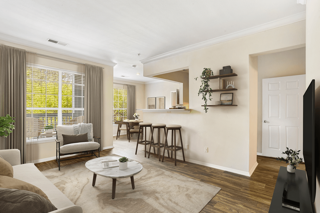 a living room with a couch chairs and a coffee table